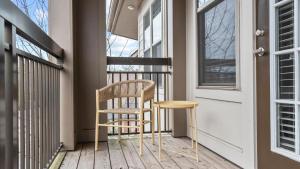 a chair sitting on a porch next to a door at Landing Modern Apartment with Amazing Amenities (ID8773X70) in Matthews