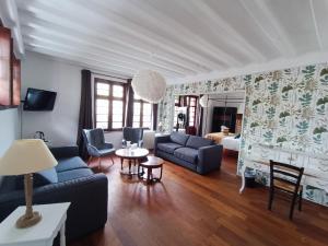 a living room with a couch and a table at Hotel La Résidence Manoir De La Salamandre in Étretat