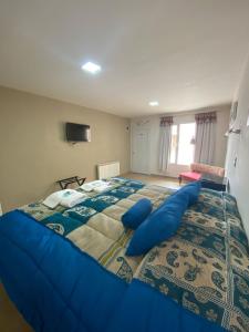 Una cama o camas en una habitación de Hotel Parador Ruta 40