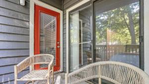 2 chaises assises sur la terrasse couverte avant d'une maison dans l'établissement Landing Modern Apartment with Amazing Amenities (ID6735X37), à Greensboro