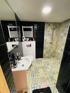 a bathroom with a sink and a shower at K&B Residence in Jarosław