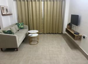 a living room with a couch and a table at BKR homestay 2bhk in Itānagar