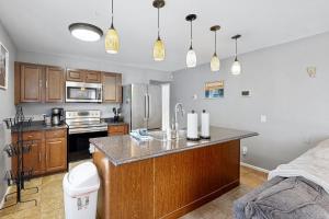 a kitchen with a large island in a room at Friendly Cove in Anchorage