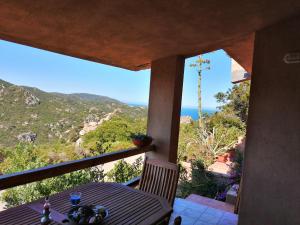 a table with a view of the ocean from a house at Villino Giovanni New 2026 in Costa Paradiso +13 photos