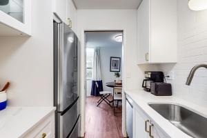 a kitchen with a sink and a refrigerator at USNA Getaway in Annapolis