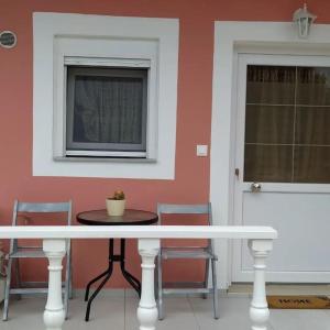 a table and chairs in a room with a window at Creta Irini's Rooms3 in Tympáki