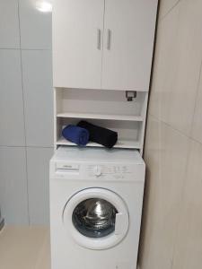 a washing machine in a bathroom with a cabinet at Creta Irini's Rooms3 in Tympáki