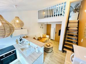 a living room with a staircase and a living room at Escapade Ensoleillé in Saint-Jean-de-Monts