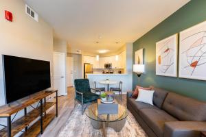 a living room with a couch and a flat screen tv at Landing Modern Apartment with Amazing Amenities (ID2415X25) in Sparks