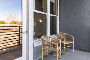 two chairs sitting on a porch next to a window at Landing Modern Apartment with Amazing Amenities (ID2415X25) in Sparks