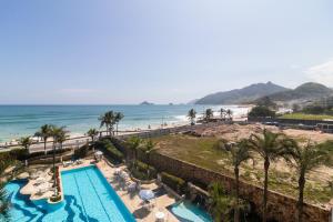 an aerial view of a resort with a swimming pool and the beach at Flat Ocean View III in Rio de Janeiro