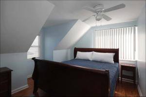 a bedroom with a bed with a ceiling fan at Island Time- beautifully renovated bay view home in Seaside Heights