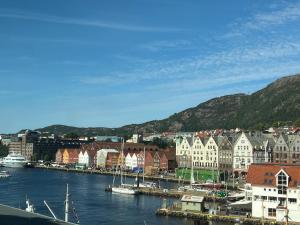 a town with a harbor with boats in the water at Vaskerelven 4 in Bergen