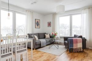 a living room with a couch and a table at Modern Scandinavian Home in Stockholm in Stockholm