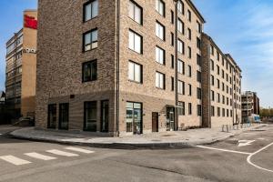 a tall brick building on the corner of a street at Modern Scandinavian Home in Stockholm in Stockholm
