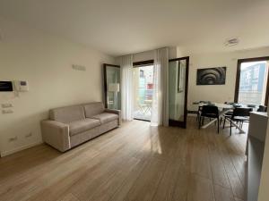 a living room with a couch and a table at Hospitami Apartment - 15 min Duomo Milano in Milan