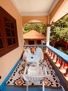 eine Veranda mit einem weißen Sofa und einem Tisch in der Unterkunft Shaman's apartment at Ya Nui beach in Phuket