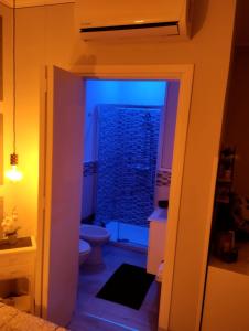a bathroom with a toilet and a sink and a window at Solemar Stay in Altavilla Milicia