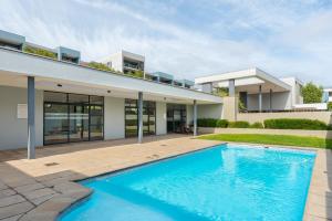 an exterior view of a house with a swimming pool at The Terraces Luxury Apartments in Cape Town