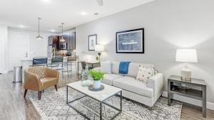a living room with a couch and a table at Landing Modern Apartment with Amazing Amenities (ID4250X31) in Frisco