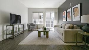 a living room with a couch and a tv at Landing Modern Apartment with Amazing Amenities (ID1191X971) in Oakland