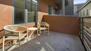 two chairs and a table on the side of a building at Landing Modern Apartment with Amazing Amenities (ID1191X971) in Oakland