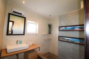 a bathroom with a sink and a mirror at Apartamento Vista Marina in Lagos +16 photos