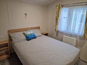 a bedroom with a bed with a blue bag on it at Nirvana, Smells Like Holiday Spirit, West Sands in Selsey