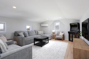 a living room with a couch and a video game at The Pelican's Perch: New Build in Seaside Heights