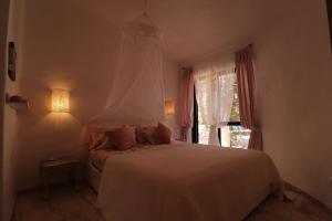 a bedroom with a white bed and a window at Villa la Perla in Carvoeiro +37 photos