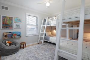 a bedroom with two bunk beds and a ladder at The Pelican's Perch: New Build in Seaside Heights