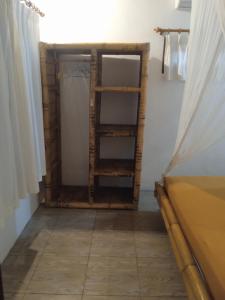 a room with a shelf next to a window at Gili Air Santay 3 in Gili Air