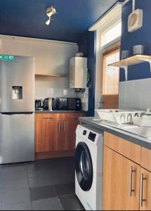 a kitchen with a dishwasher and a washer and dryer at Entire 2 bedroom house in Hackney in London