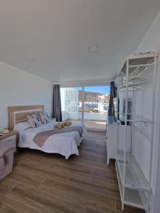 a bedroom with a bed and a large window at Alojamientos Agaete Pueblo Nº9 in Agaete