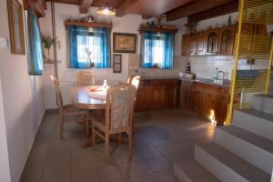 a kitchen with a table and chairs and a sink at Zidanica Balantič in Dobrovnik
