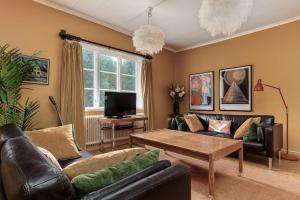 uma sala de estar com um sofá e uma mesa de centro em Historic lakeside villa - ski, boat, relax in nature em Sunnansjö