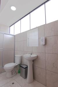 a bathroom with a toilet and a sink at Palacio del Sur in Lurín