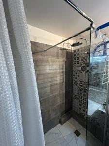 a shower with a glass door in a bathroom at Disney/Paris RER A Parking Privé. in Champs-Sur-Marne