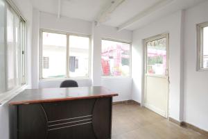 an office with a wooden desk in a room with windows at OYO Hotel Shahnai Garden in Bhopal