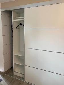 a closet with white drawers in a room at Eco Overnight Inn 