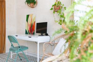 a desk with a computer and a chair in a room at A remarkable Eco Home in Gozo in Nadur