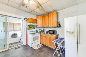 a kitchen with wooden cabinets and a refrigerator at Pet-Friendly North Carolina Abode - Deck and Hot Tub in Concord