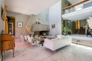 a living room with a white couch and a piano at Villa - La champenoise - Hamac Suites in Saint-Didier-au-Mont-dʼOr