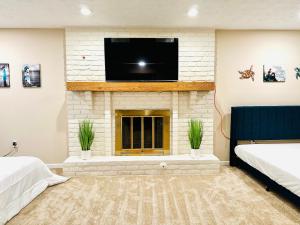 a living room with a fireplace with a flat screen tv at Ocean Palace -12 Guests- close to I-75-Amazing Location!! in Maud