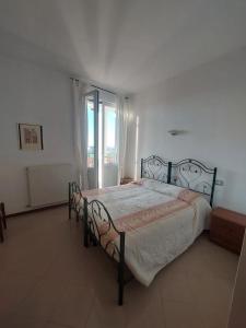 a bedroom with a bed and a large window at Il Portichetto in Rivergaro