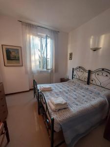 a bedroom with a bed with chairs and a window at Il Portichetto in Rivergaro