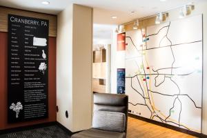 a chair in front of a wall with a map at TownePlace Suites by Marriott Pittsburgh Cranberry Township in Cranberry Township