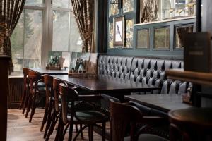 a row of tables and chairs in a restaurant at The Ullswater Inn- The Inn Collection Group in Glenridding