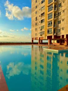 a large pool of water in front of a building at Normanis Homestay in Kota Bharu
