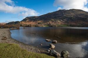 a view of a lake with a mountain in the background at The Ullswater Inn- The Inn Collection Group in Glenridding